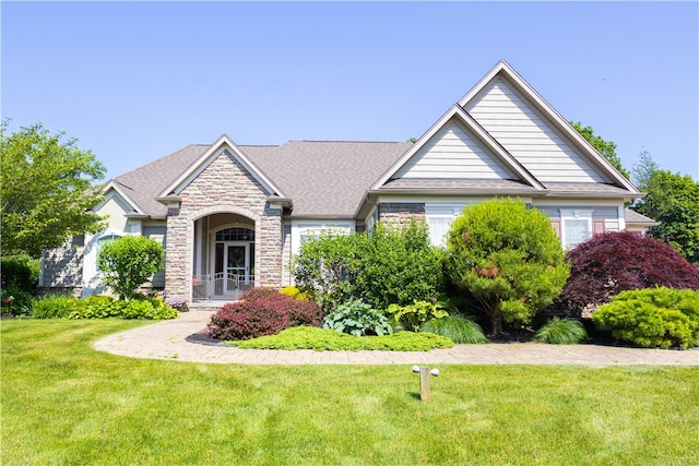 84 Watersong, Penfield, NY 14580 - view of front of house featuring stone siding and a front lawn