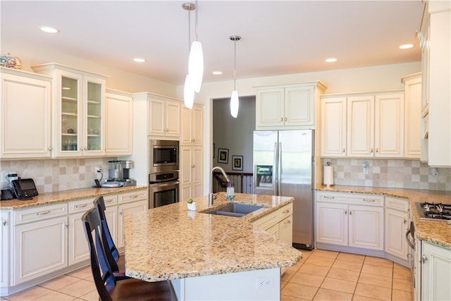 84 Watersong, Penfield, NY 14580 - kitchen featuring stainless steel appliances, light tile patterned floors, backsplash, a kitchen bar, and recessed lighting