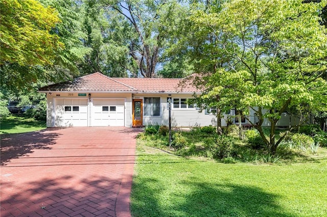 500 Pine Grove Ave, Irondequoit, NY 14617 - view of front of property featuring an attached garage, driveway, a front yard, and a tiled roof