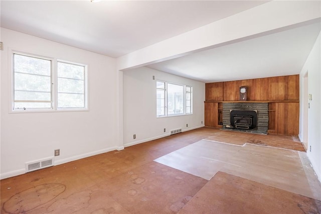 500 Pine Grove Ave, Irondequoit, NY 14617 - unfurnished living room with a wood stove and baseboards