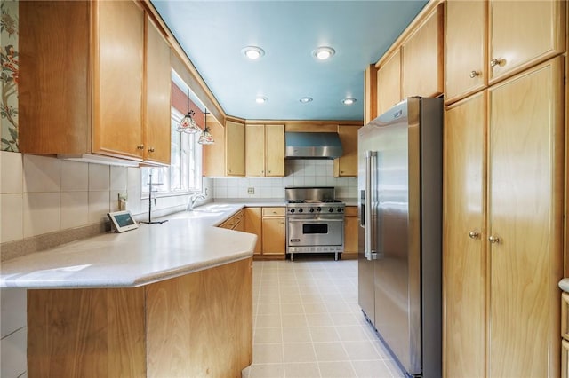 500 Pine Grove Ave, Irondequoit, NY 14617 - kitchen with high quality appliances, wall chimney exhaust hood, light countertops, tasteful backsplash, and a peninsula