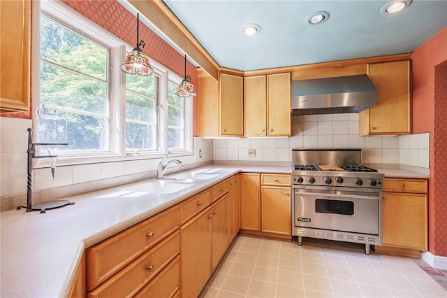 500 Pine Grove Ave, Irondequoit, NY 14617 - kitchen with premium stove, wall chimney exhaust hood, light countertops, backsplash, and recessed lighting