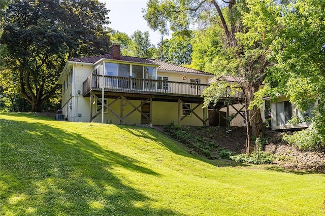 500 Pine Grove Ave, Irondequoit, NY 14617 - back of property with a chimney, a yard, a wooden deck, and a sunroom