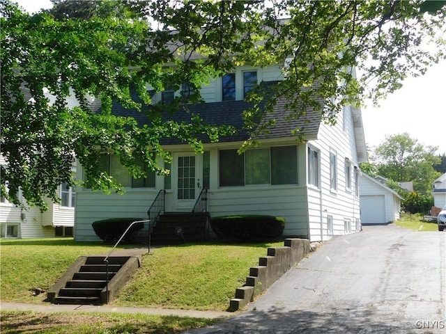 205 Shotwell Park Unit 100, Syracuse, NY 13206 - obstructed view of property featuring entry steps, a front lawn, roof with shingles, a garage, and an outdoor structure