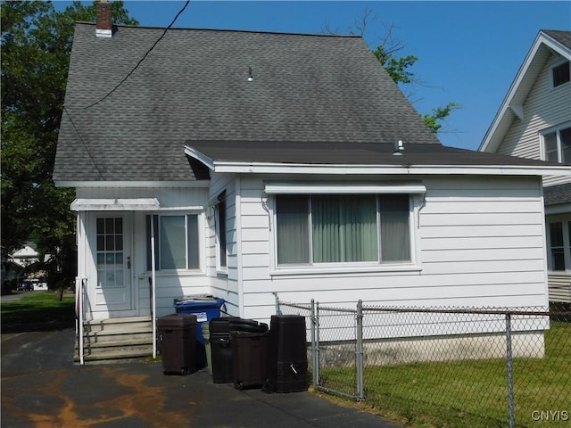 205 Shotwell Park Unit 100, Syracuse, NY 13206 - view of home's exterior with entry steps, a chimney, and roof with shingles