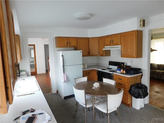 205 Shotwell Park Unit 100, Syracuse, NY 13206 - kitchen featuring white appliances, under cabinet range hood, brown cabinetry, and light countertops