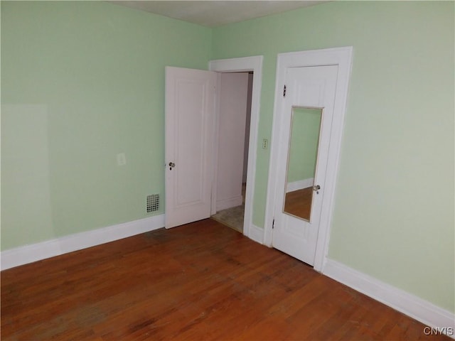 205 Shotwell Park Unit 100, Syracuse, NY 13206 - unfurnished bedroom featuring wood finished floors and baseboards
