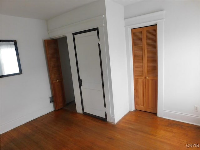 205 Shotwell Park Unit 100, Syracuse, NY 13206 - unfurnished bedroom with wood finished floors
