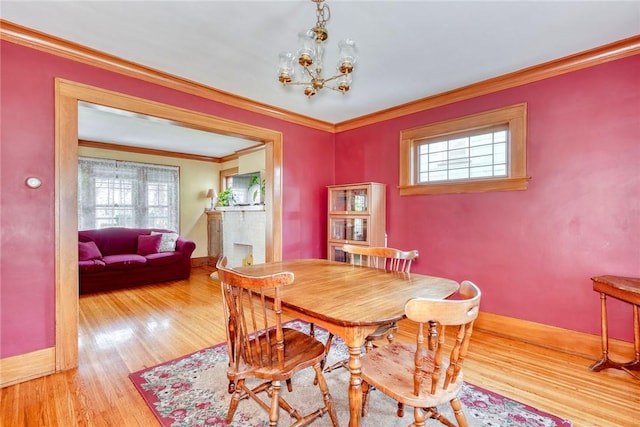 103 Culver Pkwy, Irondequoit, NY 14609 - dining room with healthy amount of natural light, wood finished floors, ornamental molding, and a chandelier