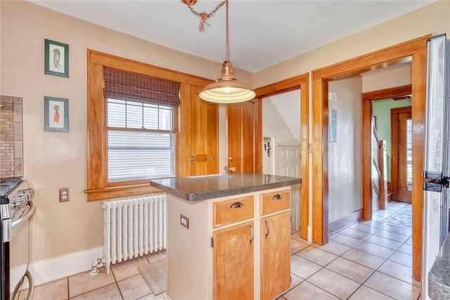 103 Culver Pkwy, Irondequoit, NY 14609 - kitchen featuring radiator, light tile patterned flooring, stainless steel gas range oven, dark countertops, and decorative light fixtures