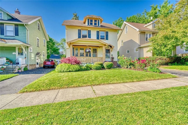 103 Culver Pkwy, Irondequoit, NY 14609 - american foursquare style home with covered porch and a front lawn