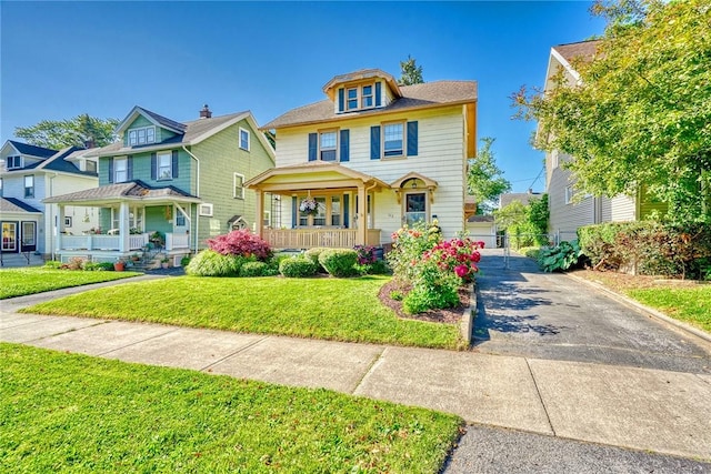 103 Culver Pkwy, Irondequoit, NY 14609 - traditional style home with a porch, a front yard, and driveway