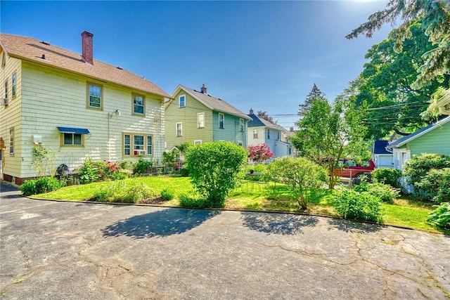 103 Culver Pkwy, Irondequoit, NY 14609 - rear view of property featuring a chimney