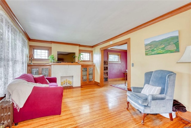 103 Culver Pkwy, Irondequoit, NY 14609 - living area featuring wood finished floors, ornamental molding, and a fireplace