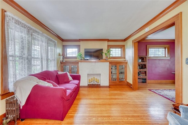 103 Culver Pkwy, Irondequoit, NY 14609 - living area with wood finished floors, a brick fireplace, and crown molding