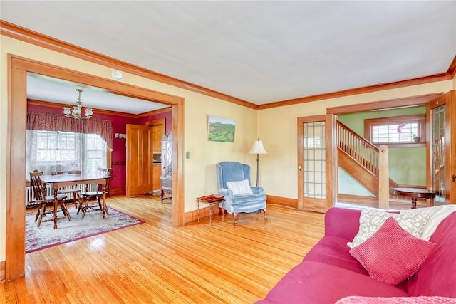 103 Culver Pkwy, Irondequoit, NY 14609 - living area with a chandelier, wood finished floors, crown molding, and stairs