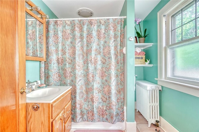 103 Culver Pkwy, Irondequoit, NY 14609 - bathroom with radiator heating unit, vanity, a shower with shower curtain, and tile patterned flooring
