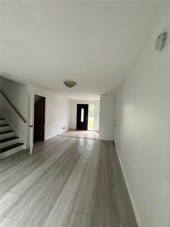 120 Valley St, Rochester, NY 14612 - unfurnished living room with stairway and light wood-style flooring