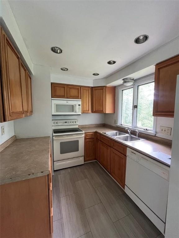 120 Valley St, Rochester, NY 14612 - kitchen featuring white appliances, brown cabinets, wood tiled floors, and light countertops
