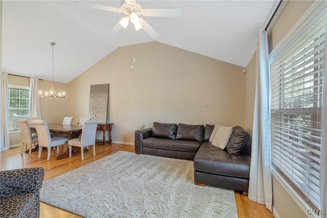 5269 Medasano Cir, Clay, NY 13041 - living room with a chandelier, lofted ceiling, light wood-style floors, and a ceiling fan
