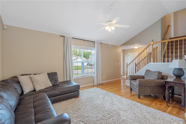 5269 Medasano Cir, Clay, NY 13041 - living area with wood finished floors, stairway, ceiling fan, and vaulted ceiling