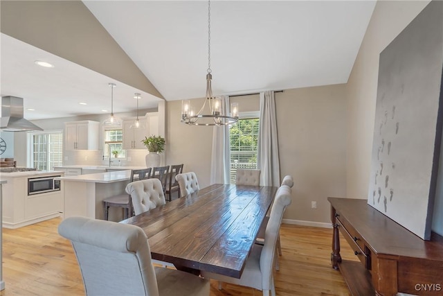 5269 Medasano Cir, Clay, NY 13041 - dining space featuring a chandelier, vaulted ceiling, light wood-type flooring, and recessed lighting