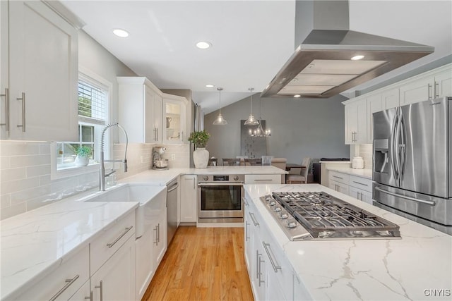 5269 Medasano Cir, Clay, NY 13041 - kitchen with stainless steel appliances, wall chimney exhaust hood, white cabinetry, light wood-style flooring, and tasteful backsplash
