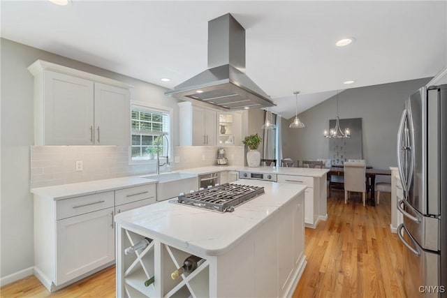 5269 Medasano Cir, Clay, NY 13041 - kitchen with stainless steel appliances, island exhaust hood, a peninsula, white cabinets, and tasteful backsplash