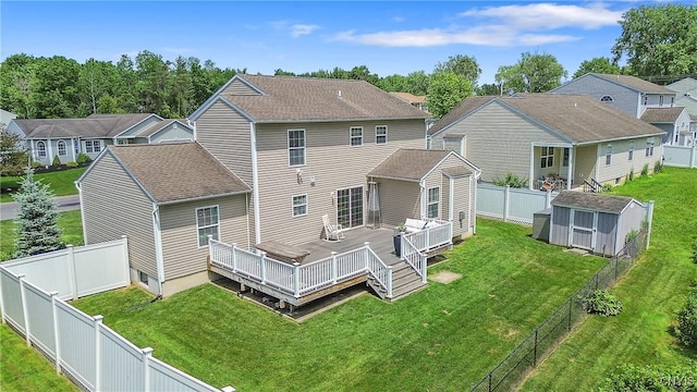 5269 Medasano Cir, Clay, NY 13041 - back of property featuring a storage unit, a deck, a fenced backyard, a residential view, and a shingled roof