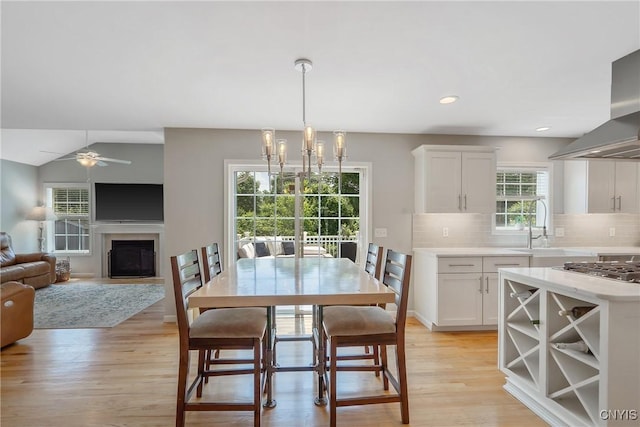 5269 Medasano Cir, Clay, NY 13041 - dining area with a fireplace, light wood-type flooring, a ceiling fan, and recessed lighting
