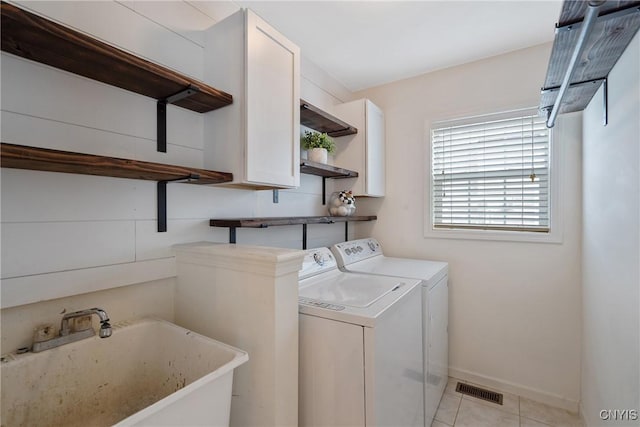 5269 Medasano Cir, Clay, NY 13041 - laundry room featuring washing machine and clothes dryer, cabinet space, and light tile patterned floors