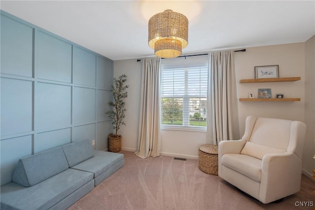 5269 Medasano Cir, Clay, NY 13041 - living area with carpet flooring, a decorative wall, and a chandelier