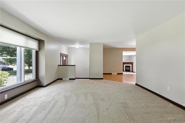53 Christine Dr, Amherst, NY 14228 - spare room with carpet flooring and a fireplace with raised hearth