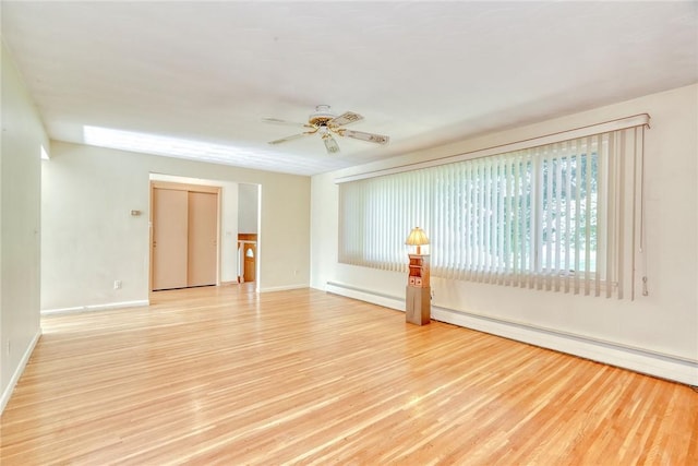 238 Fisher Rd, Chili, NY 14624 - empty room with light wood finished floors, baseboard heating, and a ceiling fan