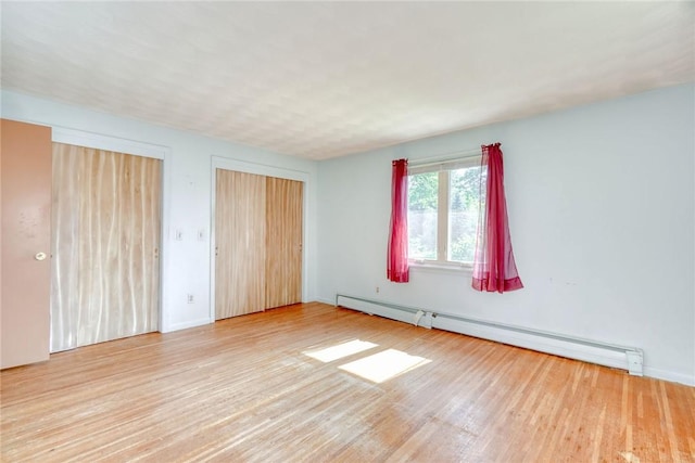 238 Fisher Rd, Chili, NY 14624 - unfurnished bedroom with a baseboard radiator and wood finished floors