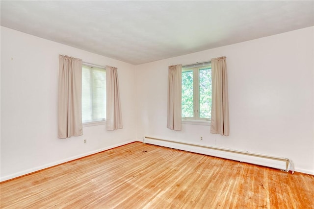 238 Fisher Rd, Chili, NY 14624 - spare room featuring a baseboard heating unit and wood finished floors