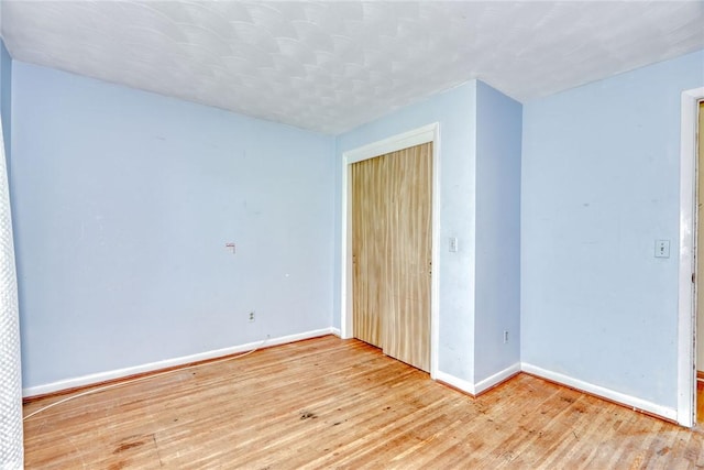 238 Fisher Rd, Chili, NY 14624 - unfurnished bedroom featuring light wood-style flooring and a closet