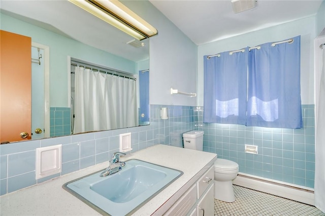 238 Fisher Rd, Chili, NY 14624 - bathroom with a baseboard heating unit, tile walls, vanity, tile patterned flooring, and wainscoting
