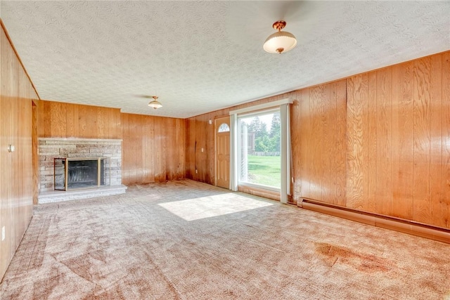 238 Fisher Rd, Chili, NY 14624 - unfurnished living room with wooden walls, a textured ceiling, baseboard heating, carpet, and a fireplace