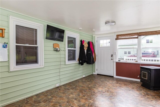 514 Maple St, Big Flats, NY 14814 - entryway featuring a wood stove, dark stone finish floors, and wood walls