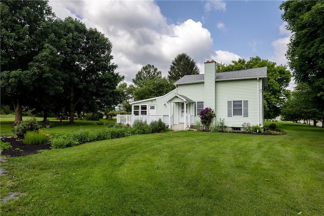 514 Maple St, Big Flats, NY 14814 - view of front facade with a chimney and a front yard