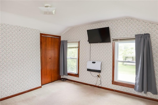 514 Maple St, Big Flats, NY 14814 - empty room with lofted ceiling, plenty of natural light, wallpapered walls, carpet, and heating unit