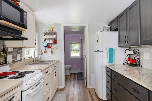 514 Maple St, Big Flats, NY 14814 - kitchen with white range with electric cooktop, black microwave, a baseboard radiator, light wood-style flooring, and backsplash