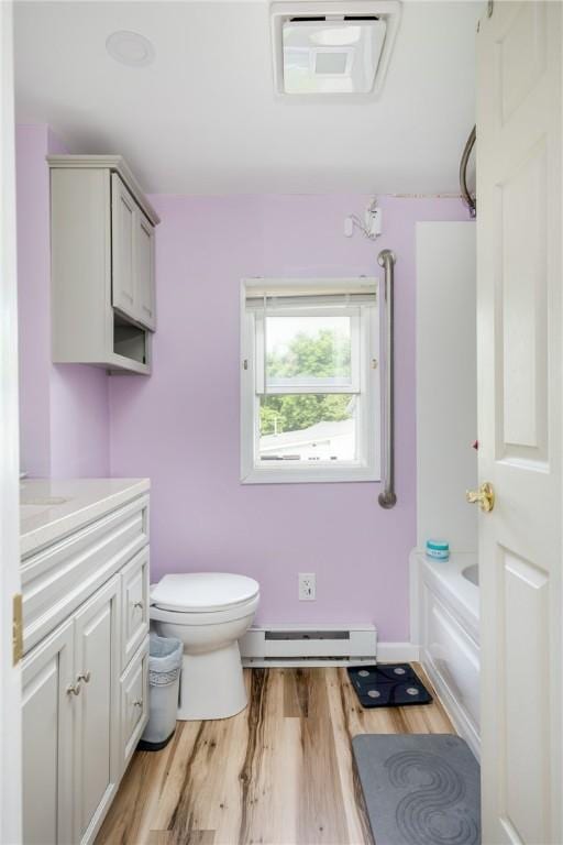 514 Maple St, Big Flats, NY 14814 - full bath with a baseboard radiator, vanity, wood finished floors, and a bathtub