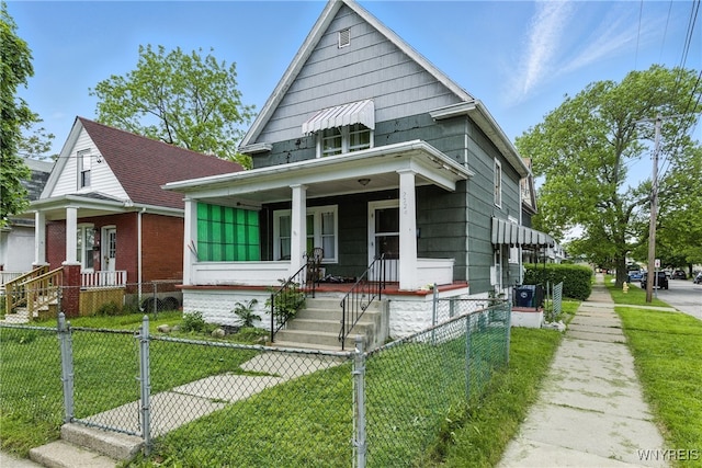 2224 Walnut Ave, Niagara Falls, NY 14301 - shotgun-style home featuring covered porch, a fenced front yard, and a gate