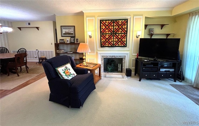 3 Homer Ln Unit B, Amherst, NY 14221 - living room with a fireplace, carpet floors, ornamental molding, and a textured ceiling