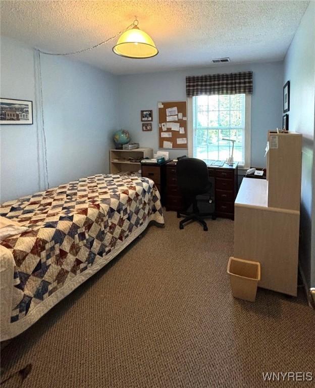 3 Homer Ln Unit B, Amherst, NY 14221 - bedroom featuring carpet flooring, a textured ceiling, and an office area