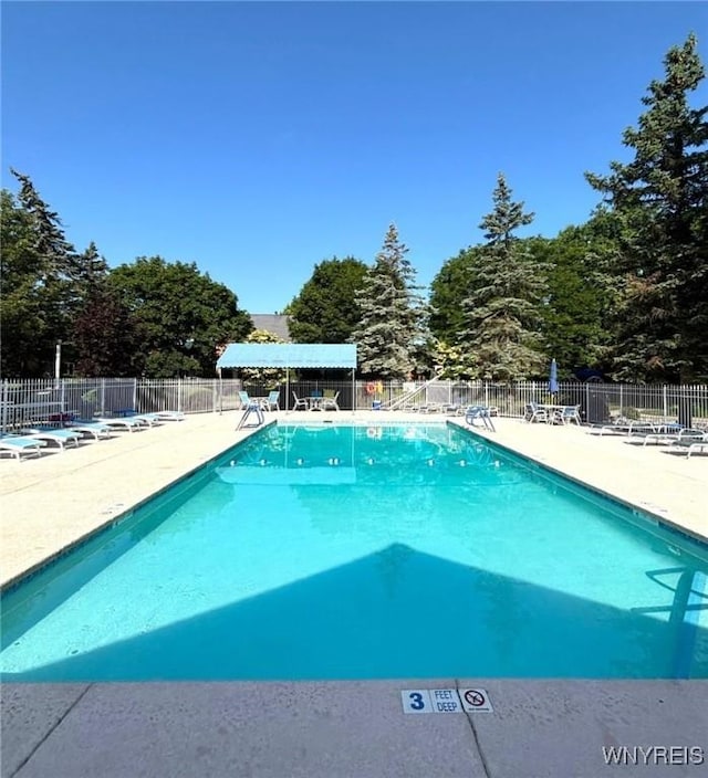 3 Homer Ln Unit B, Amherst, NY 14221 - community pool featuring a patio and view of scattered trees