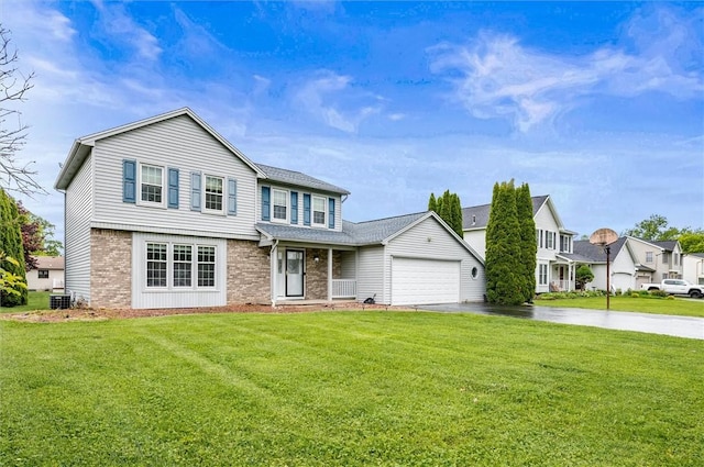73 Hazel Bark Run, Gates, NY 14606 - view of front of house featuring driveway, brick siding, a front yard, and a garage