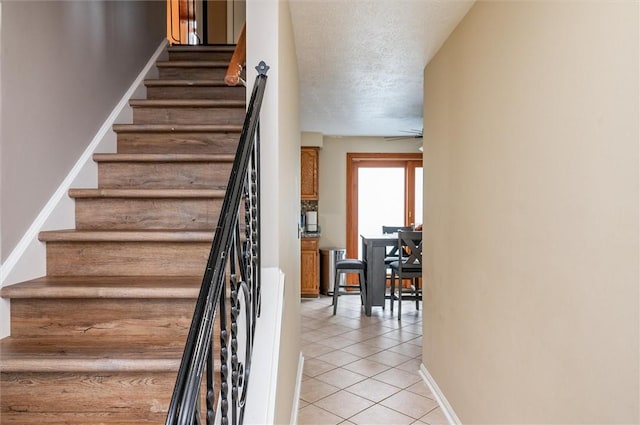 73 Hazel Bark Run, Gates, NY 14606 - stairway featuring tile patterned flooring, a ceiling fan, and a textured ceiling